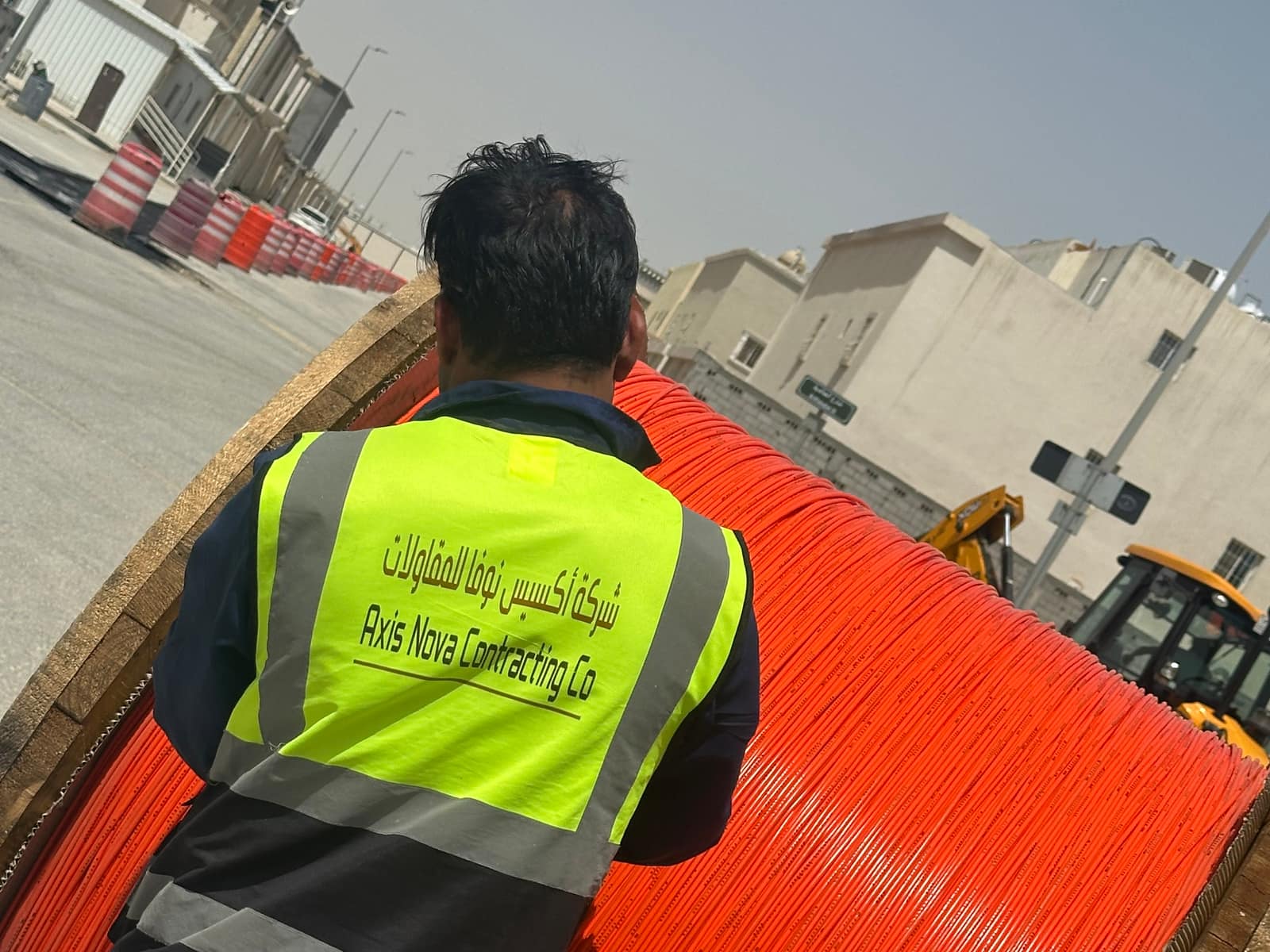 Axis Nova crew with a fiber optic cable reel on a Riyadh street